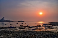 Sunset over the Black Sea coast with fishing boats gently rocking near the shore.