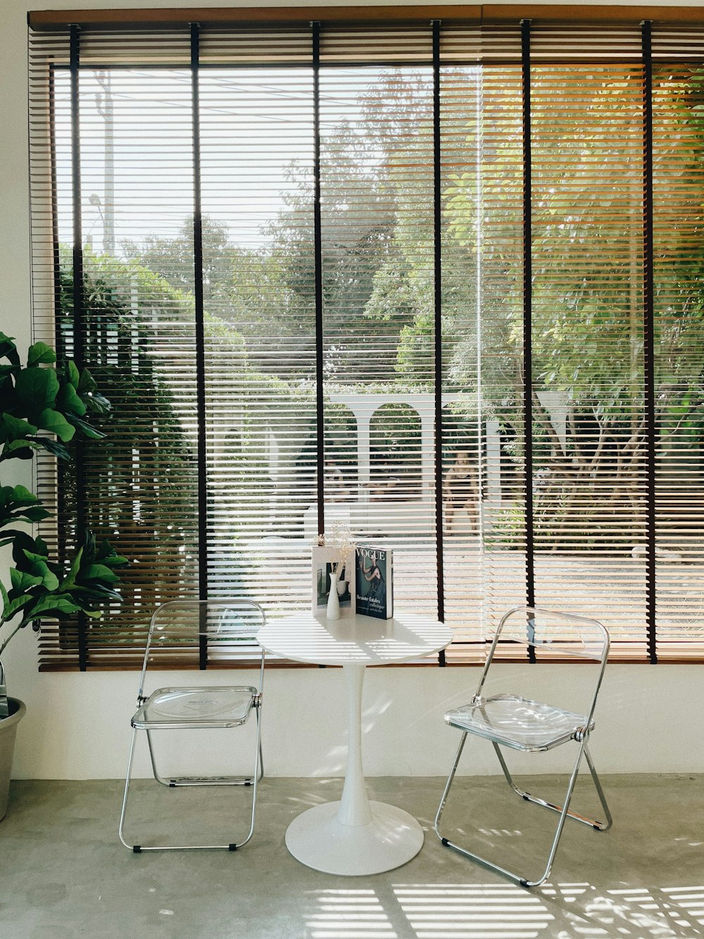 two chairs and a table in front of a window