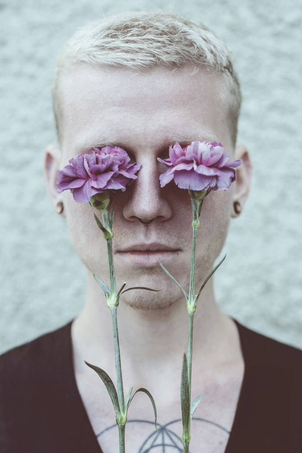 a man with three flowers in his eyes