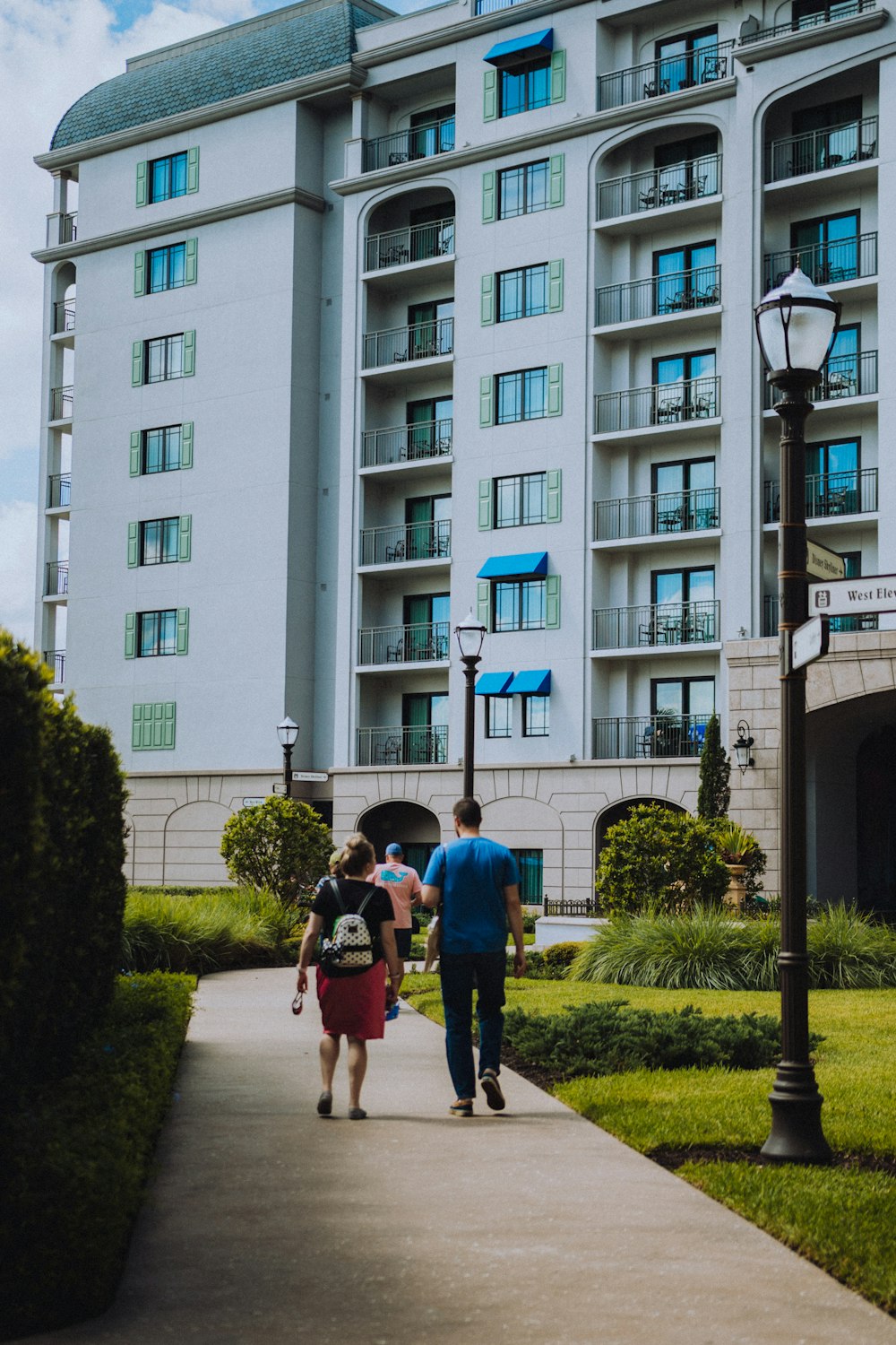 a couple of people walking down a sidewalk