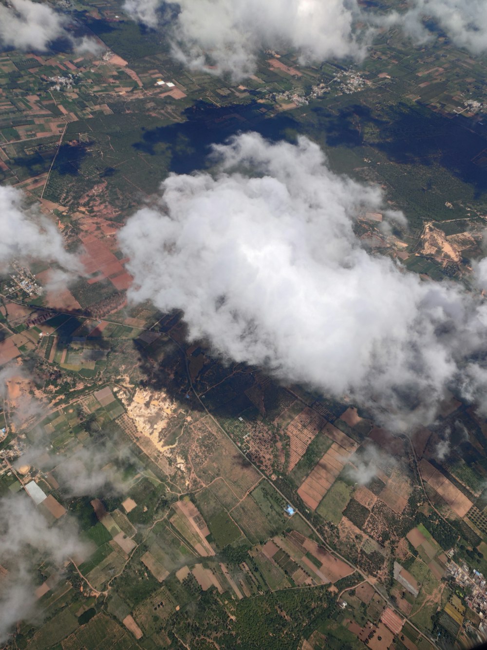 an aerial view of clouds over a rural area