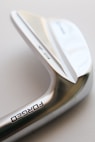 a close up of a metal object with a white background