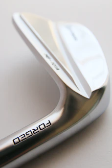 a close up of a metal object with a white background