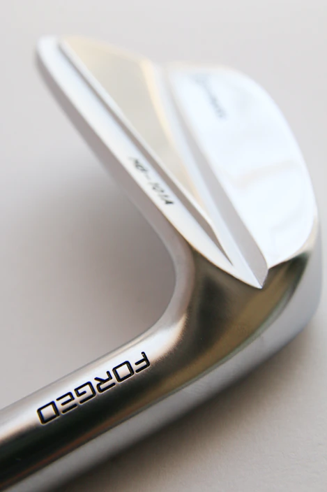 a close up of a metal object with a white background
