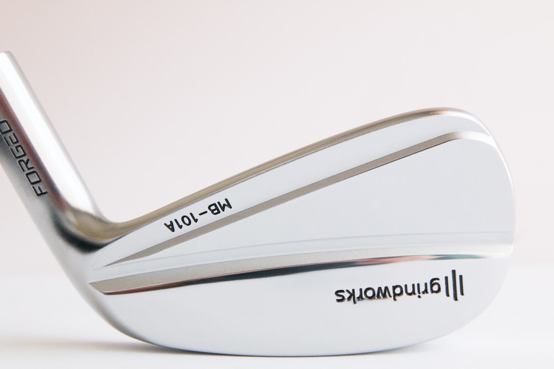 a close up of a golf club with a white background