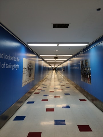 Bright and colorful school corridor filled with student artwork and motivational posters.