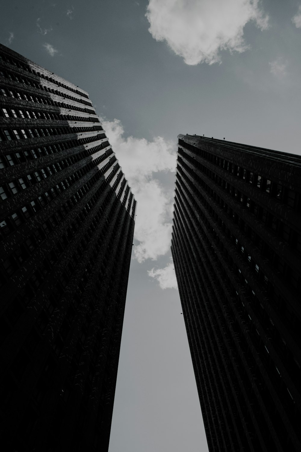 a black and white photo of two tall buildings