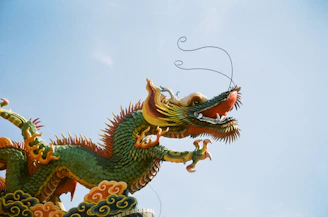 a dragon statue on top of a building