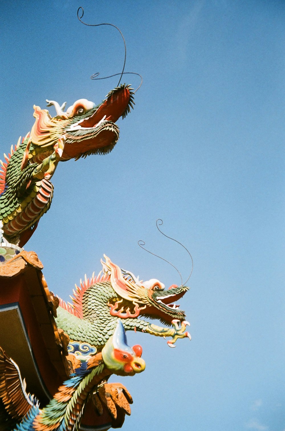 a dragon statue on top of a building