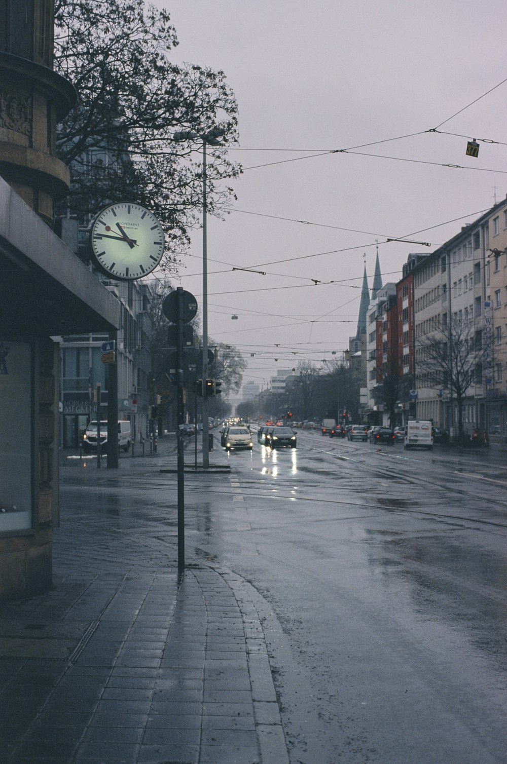 a city street with a clock on the side of it