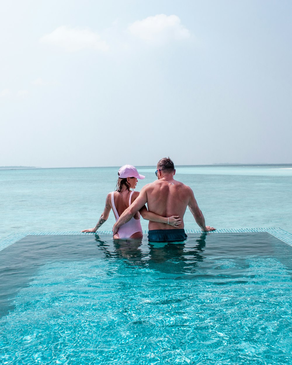 a man and a woman are sitting in the water