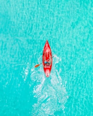 a person in a red kayak in the water