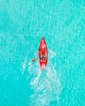 a person in a red kayak in the water
