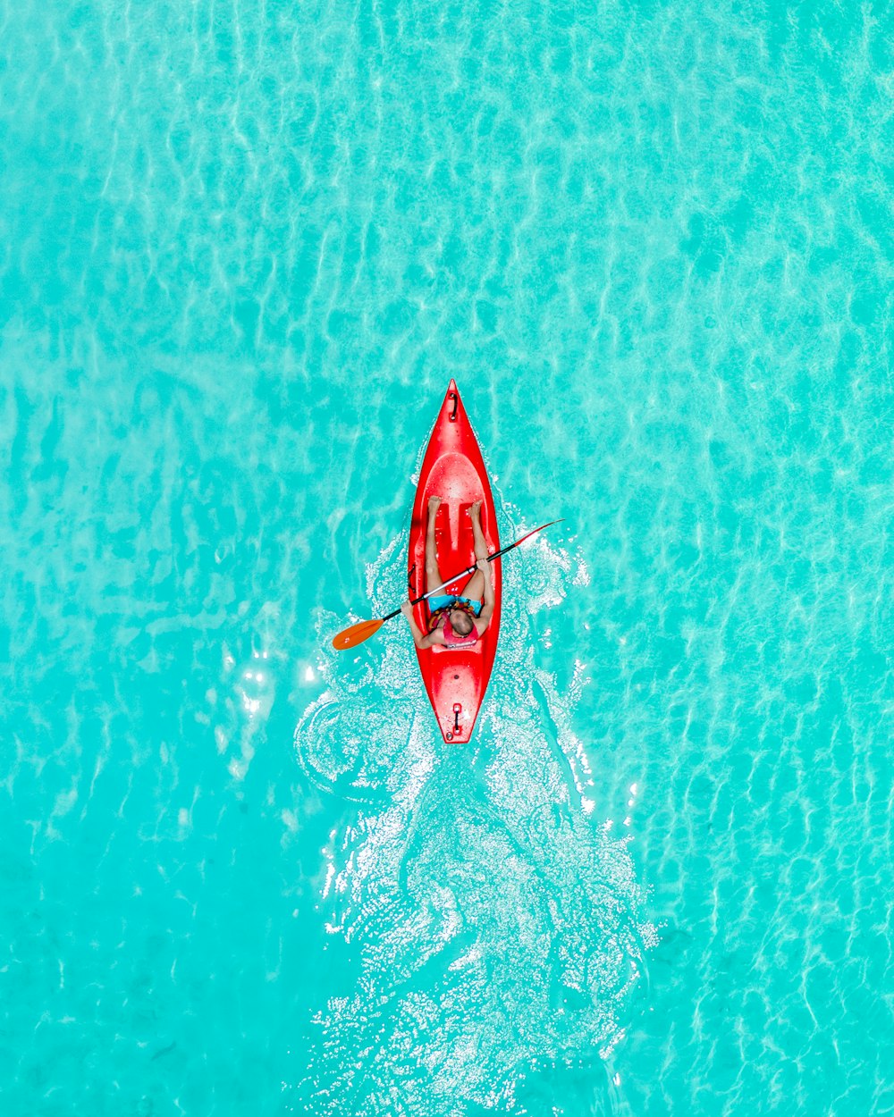 a person in a red kayak in the water