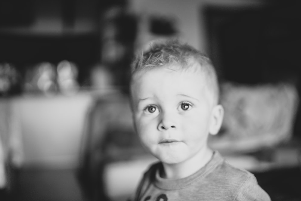 a black and white photo of a young boy