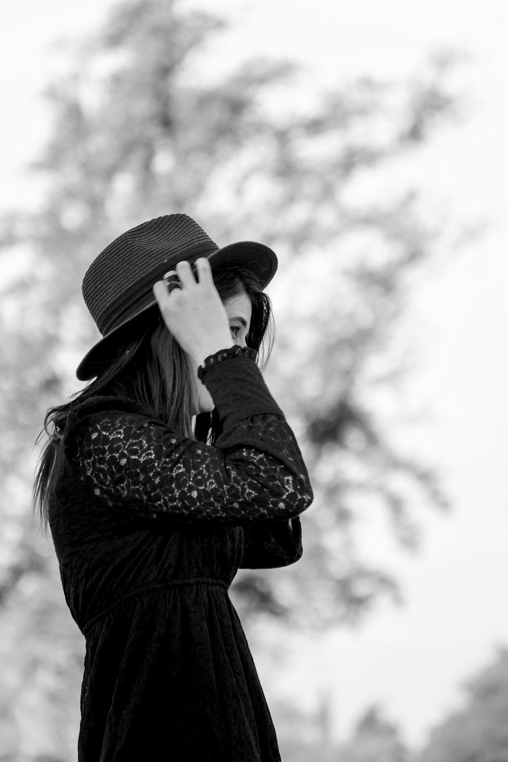 a woman in a hat is talking on a cell phone