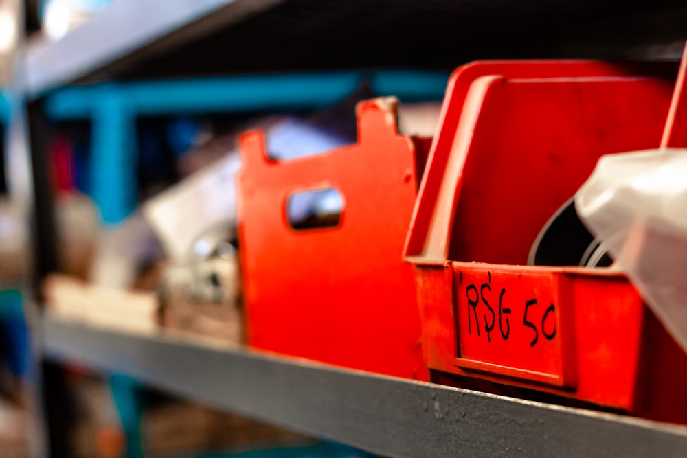 a shelf filled with lots of red boxes