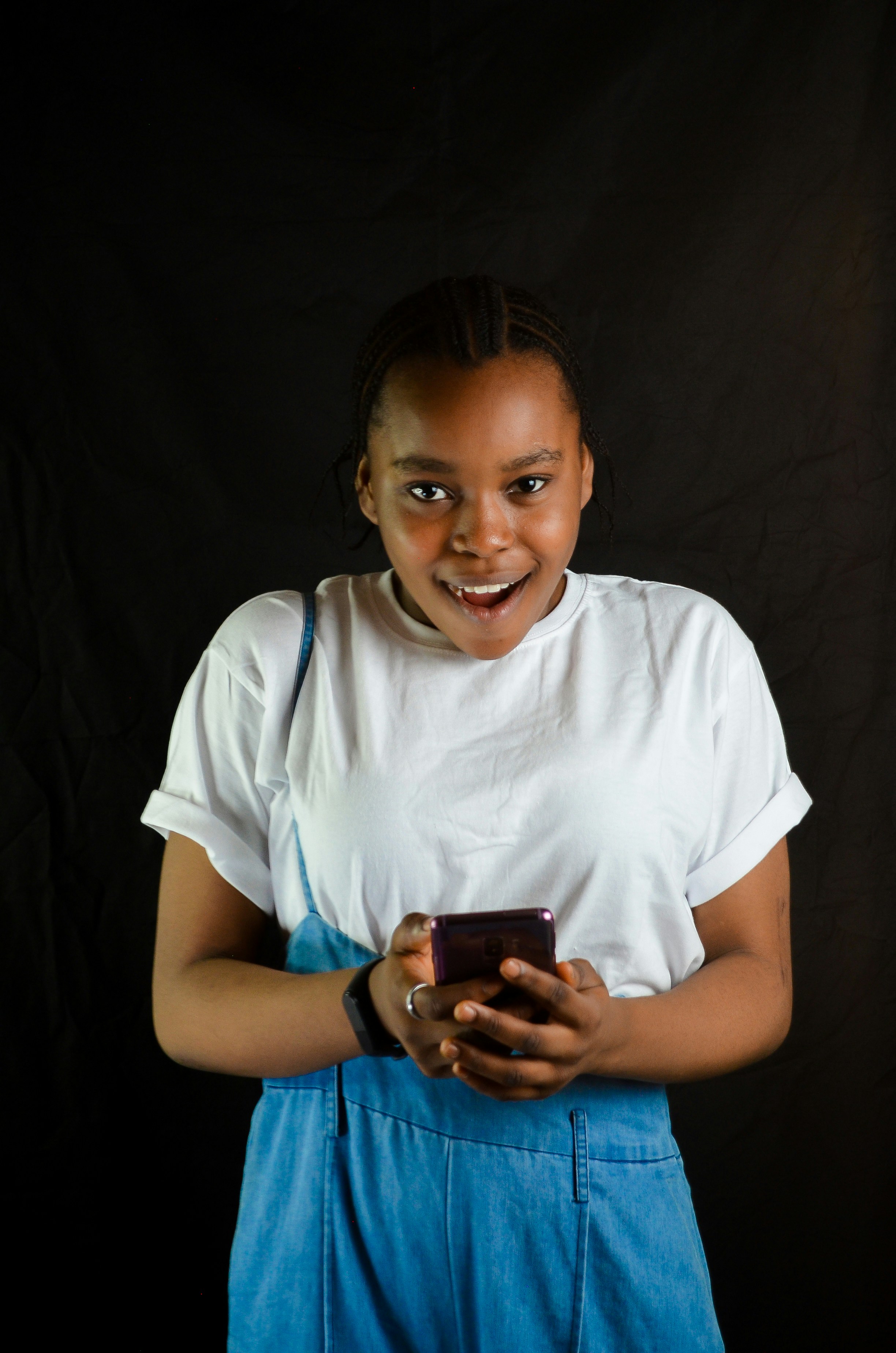 a woman smiling while holding a cell phone