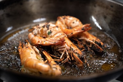 a frying pan filled with cooked shrimp