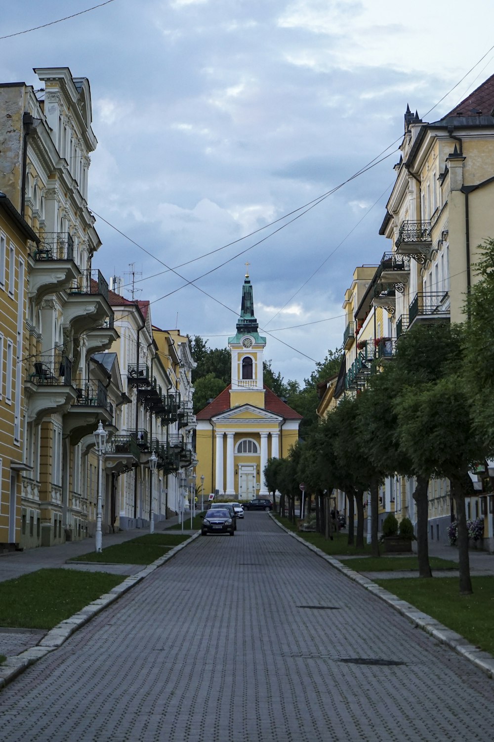 a narrow city street with buildings on the side of a road