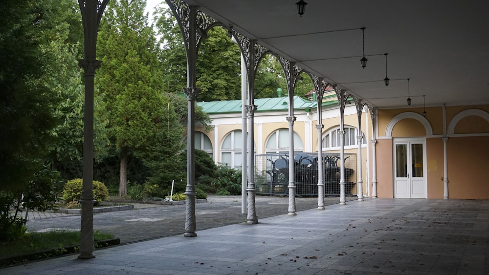 a building with columns and a green roof