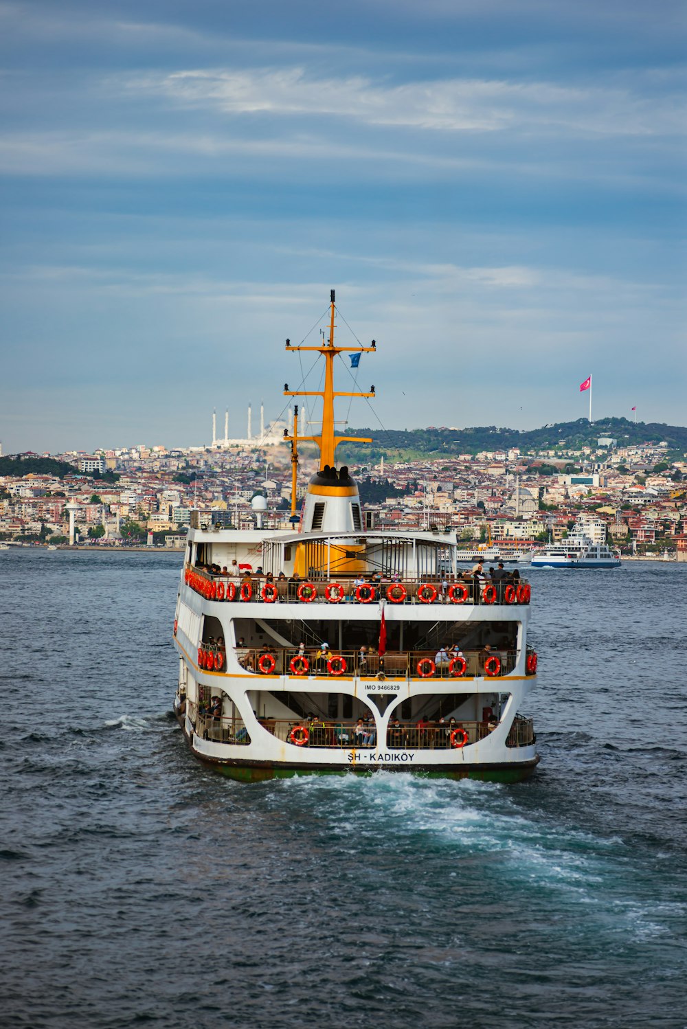 a large white and orange boat in the water