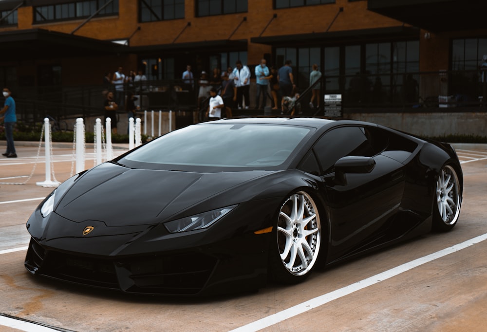 a black sports car parked in a parking lot