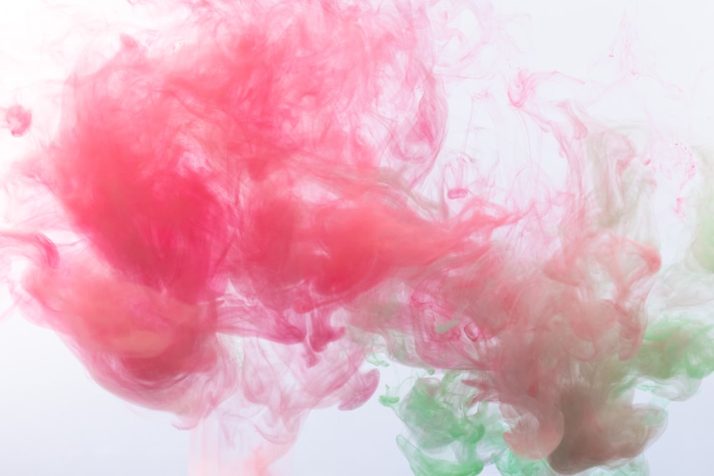 a mixture of colored ink in water on a white background