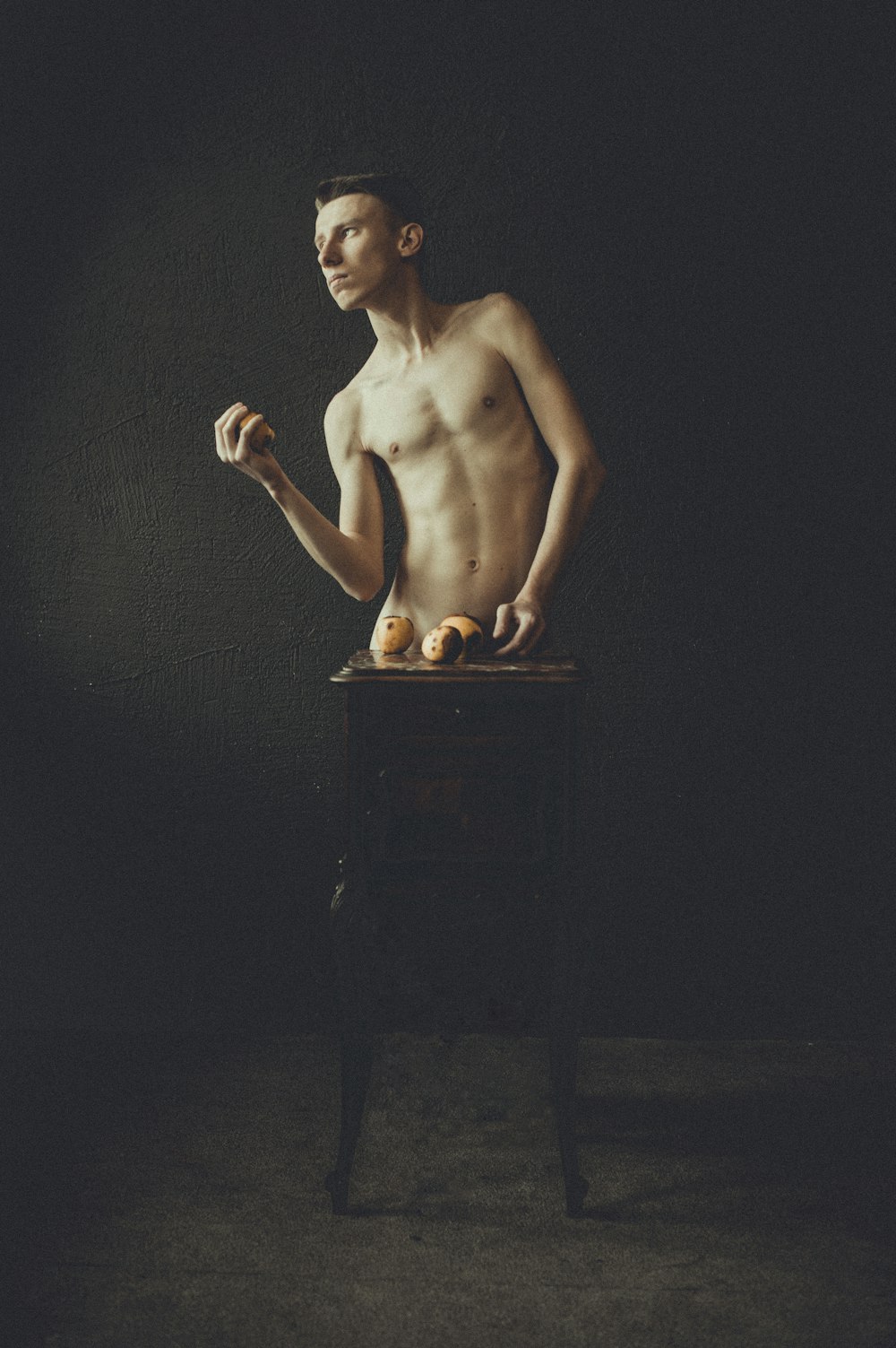 a naked man standing on top of a table