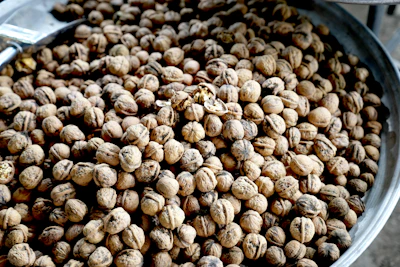 a metal bowl filled with lots of nuts