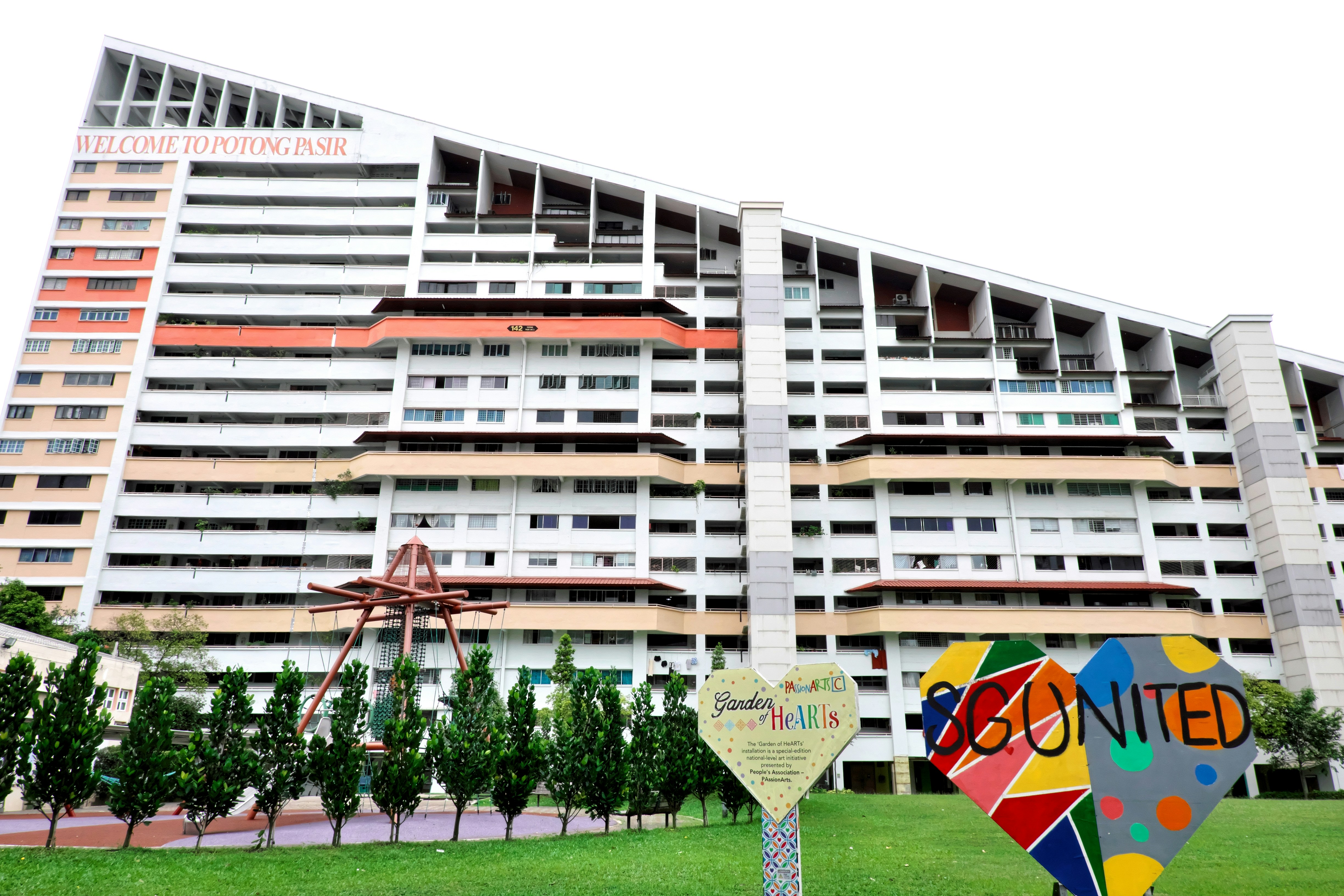 a very tall building with a colorful sign in front of it