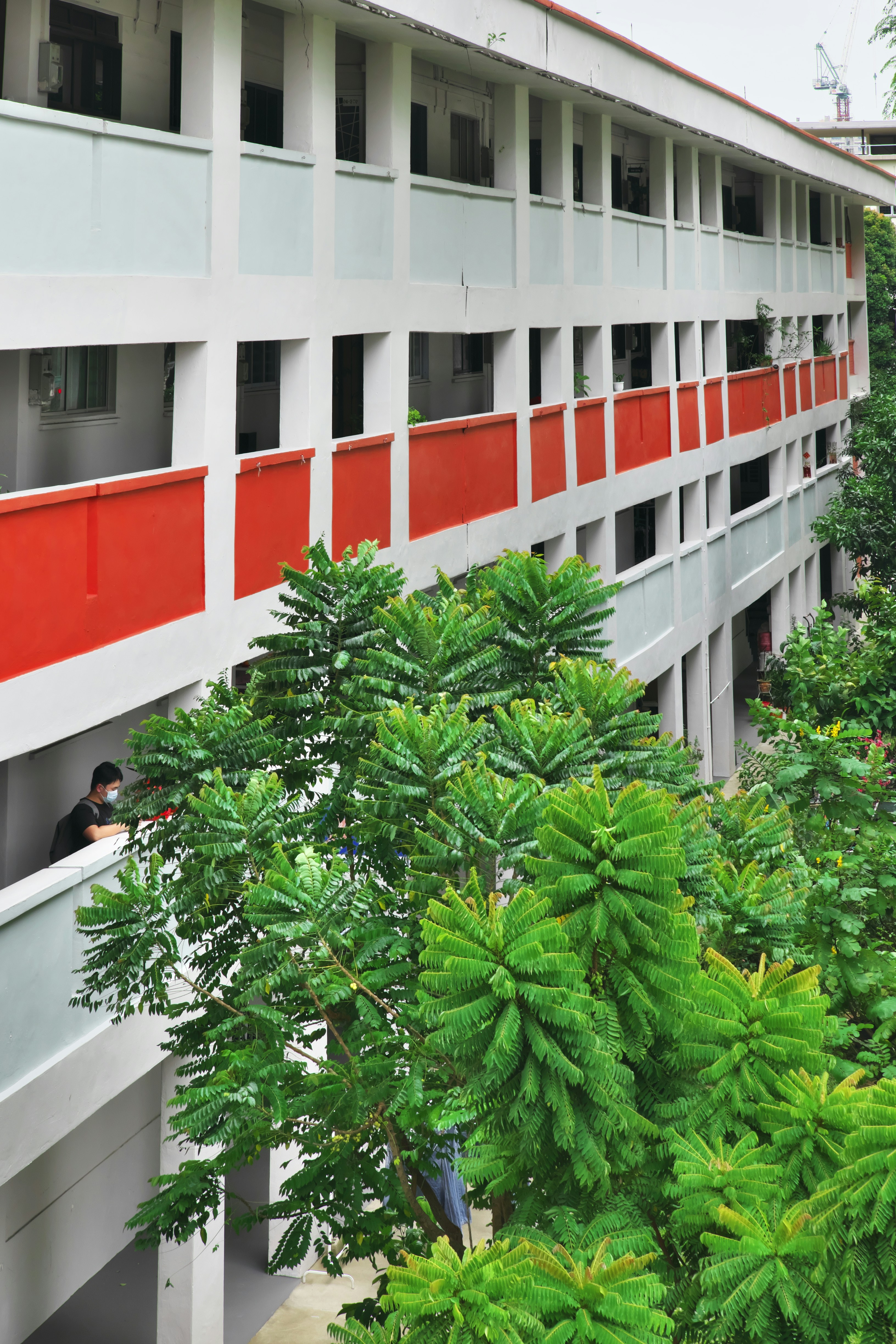 a red and white building with trees in front of it