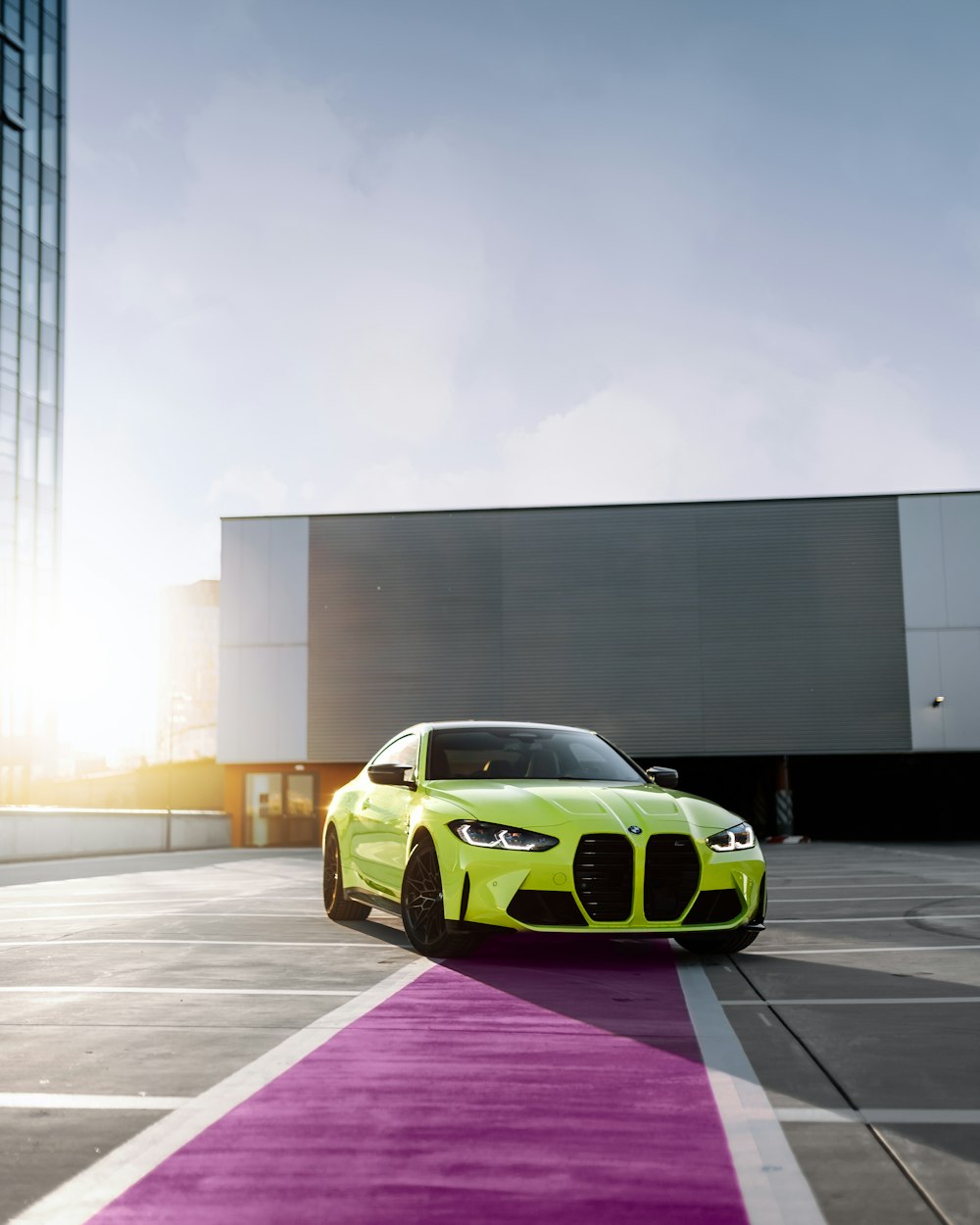 a lime green car parked on a parking lot