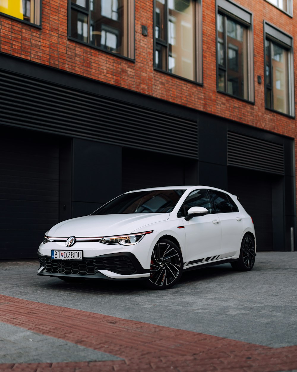 a white car parked in front of a building