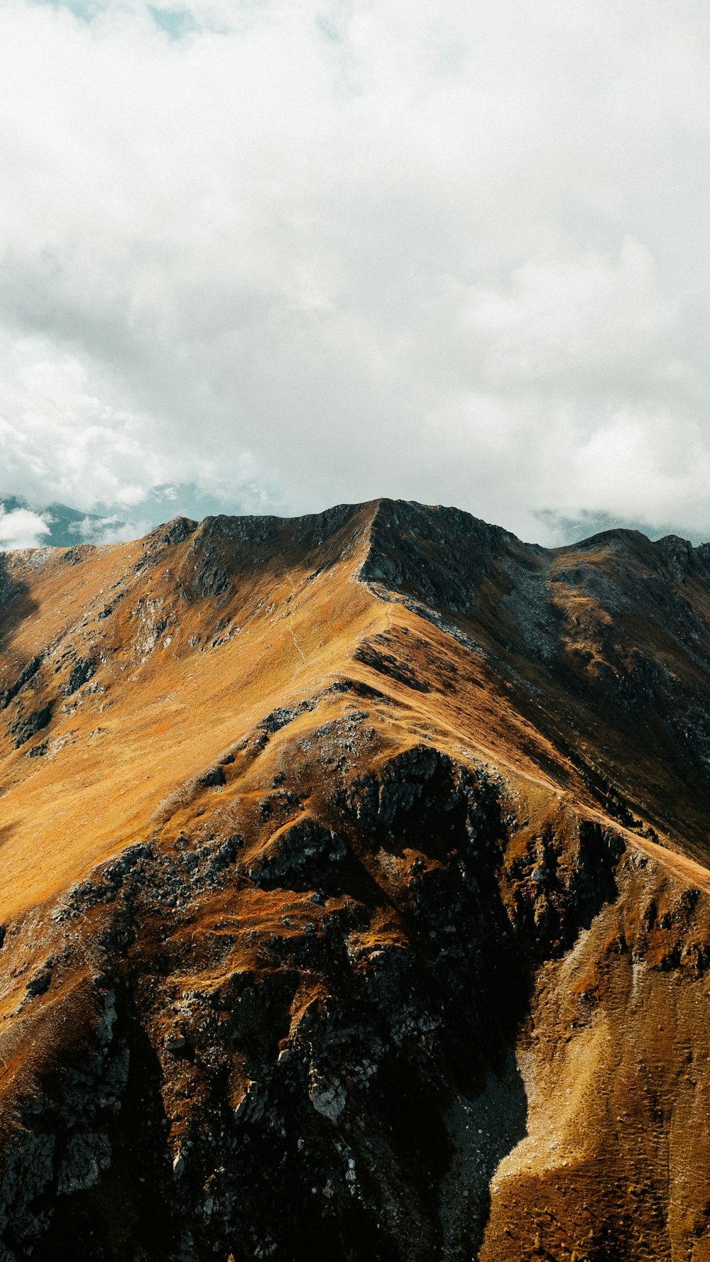 a view of a mountain with a sky background