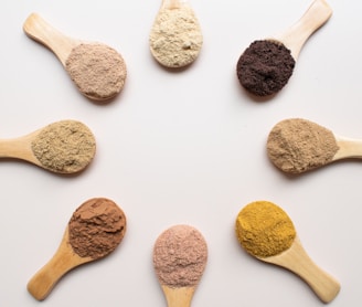 six different types of powdered spoons arranged in a circle