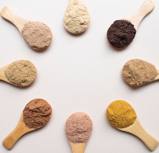 six different types of powdered spoons arranged in a circle