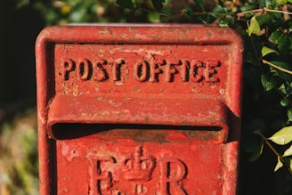 a red post box with the word post office written on it