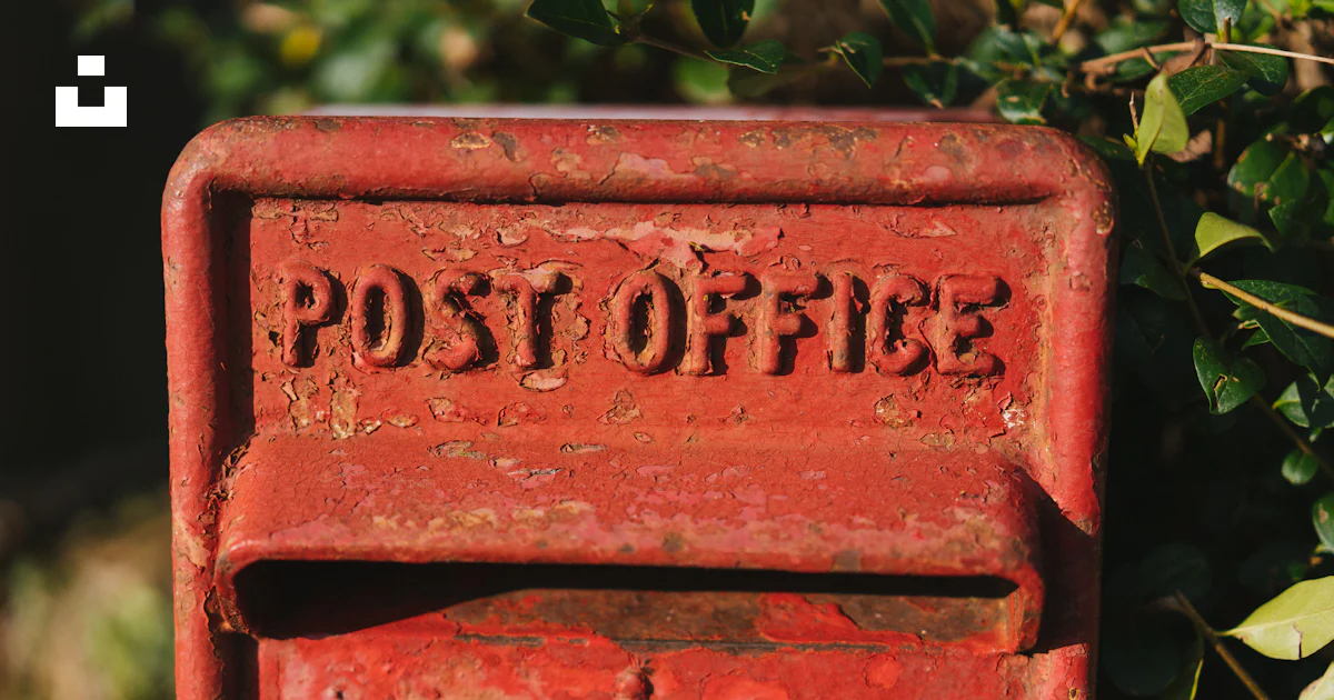 A red post box with the word post office written on it photo – Free Red ...