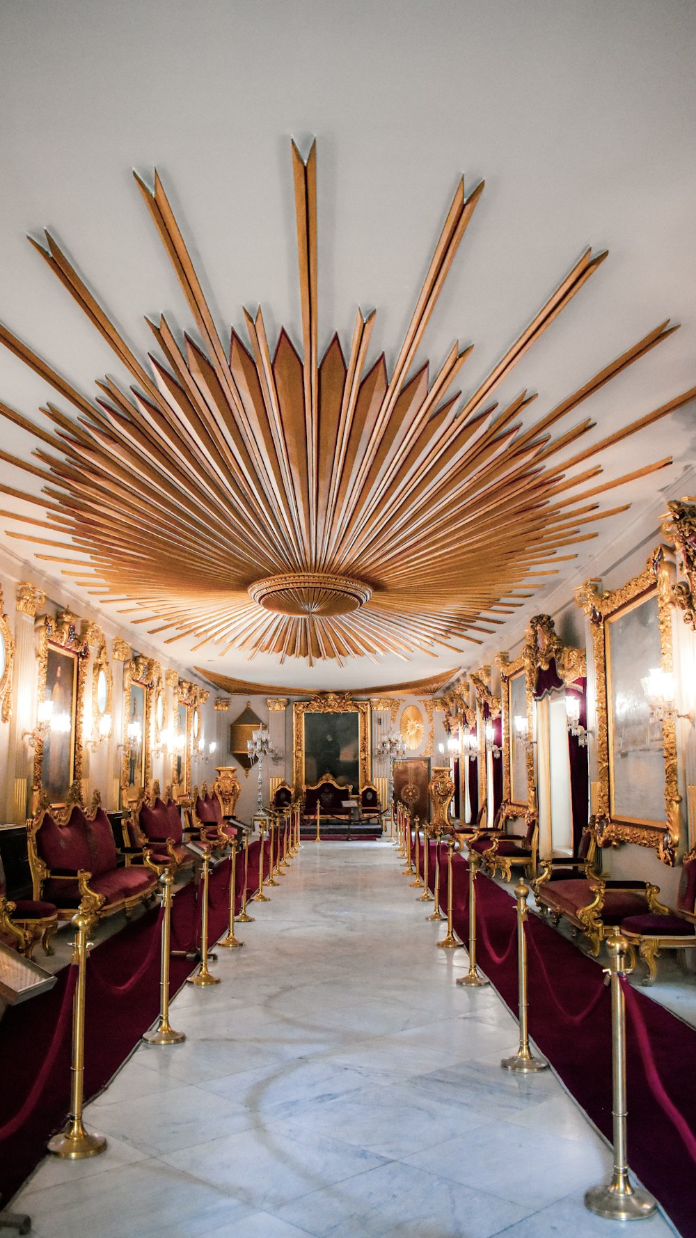 a room filled with lots of gold and red furniture