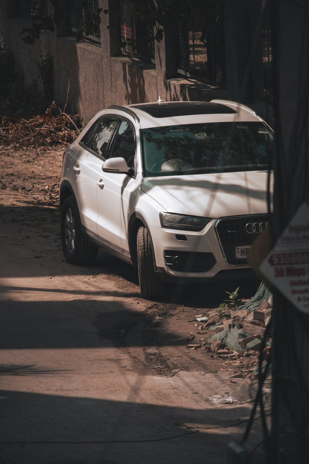 a white car parked on the side of a road