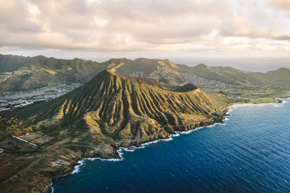 an aerial view of a mountain and the ocean