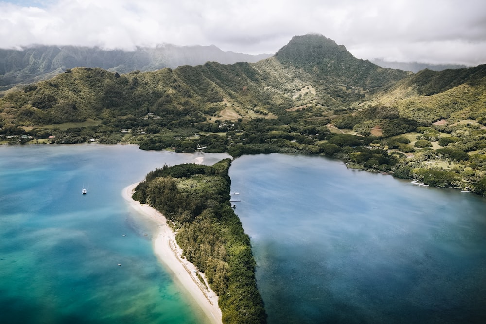 an aerial view of a tropical island surrounded by mountains
