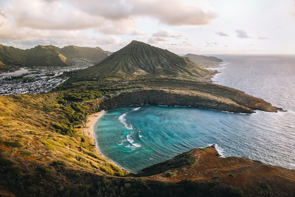 an aerial view of a beach and a mountain