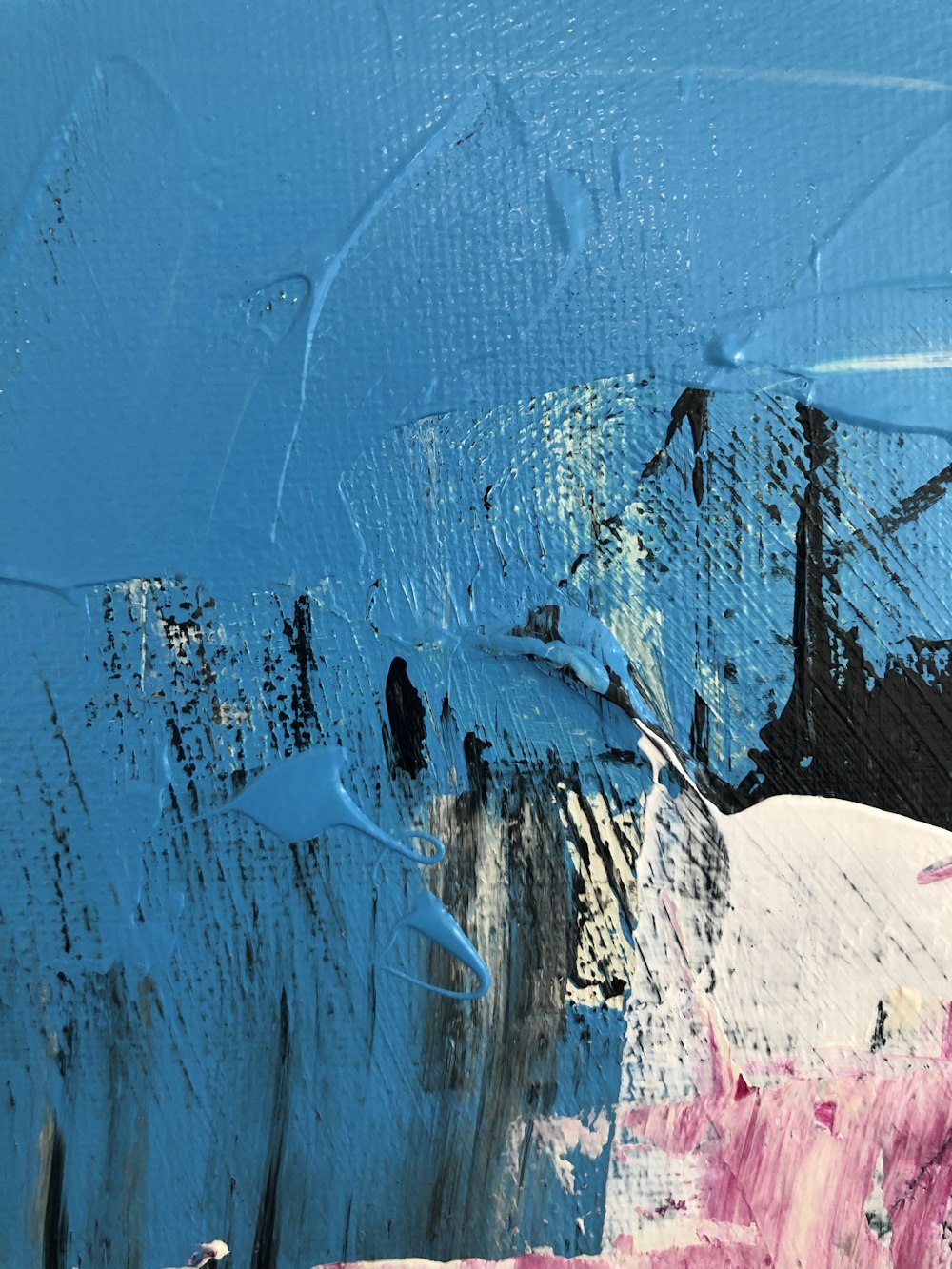 a painting of blue and pink paint on a wall