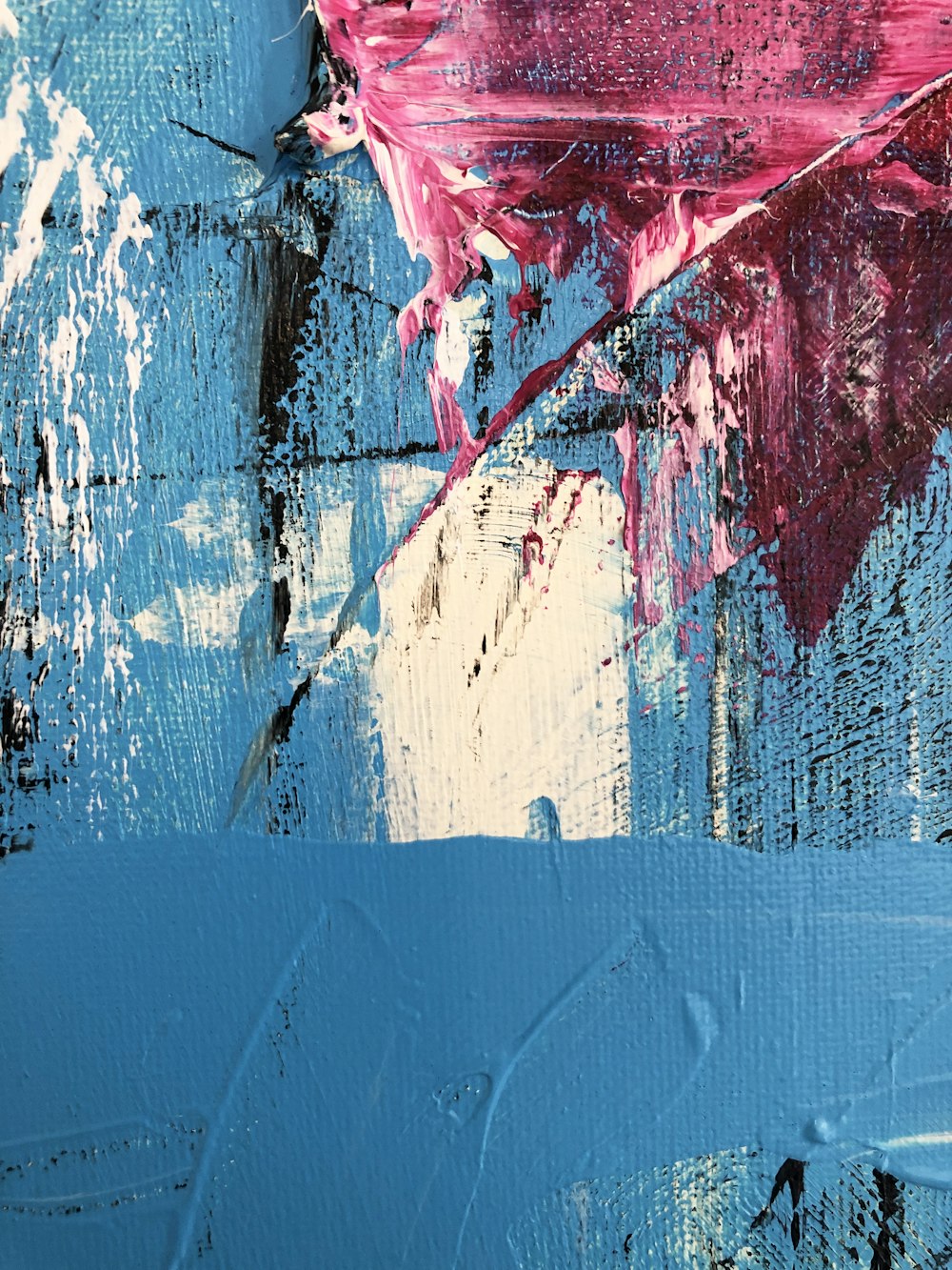 a close up of a blue and pink painting