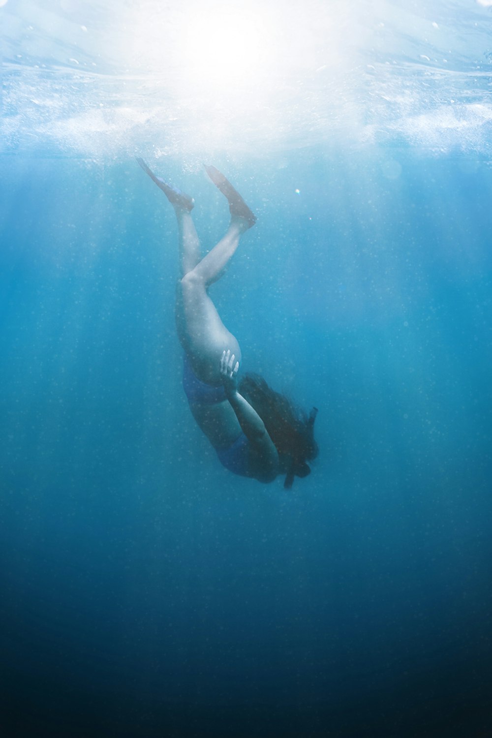 a man swimming in the ocean under water