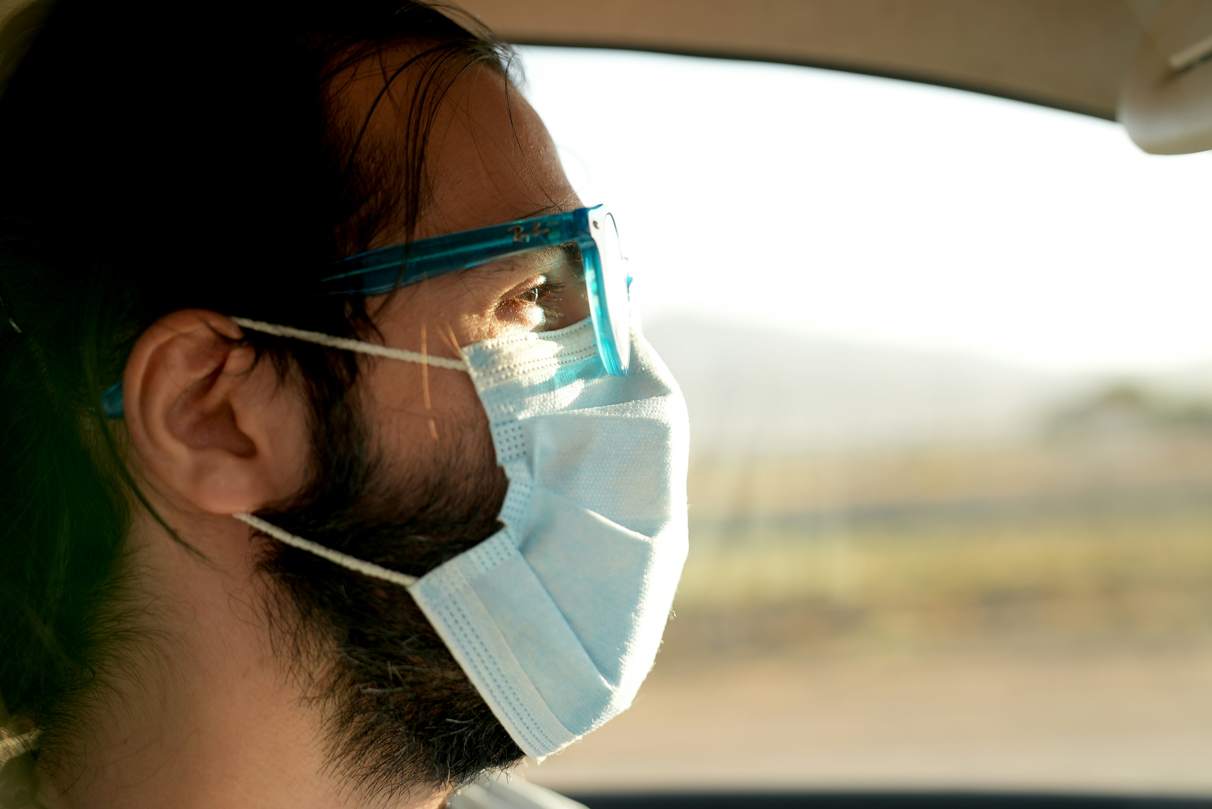 A man wearing a face mask in a car photo Free Brown Image on Unsplash