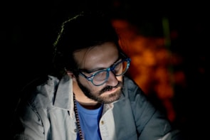 Bright photo of a model wearing stylish blue light blocking glasses against a soft white background.