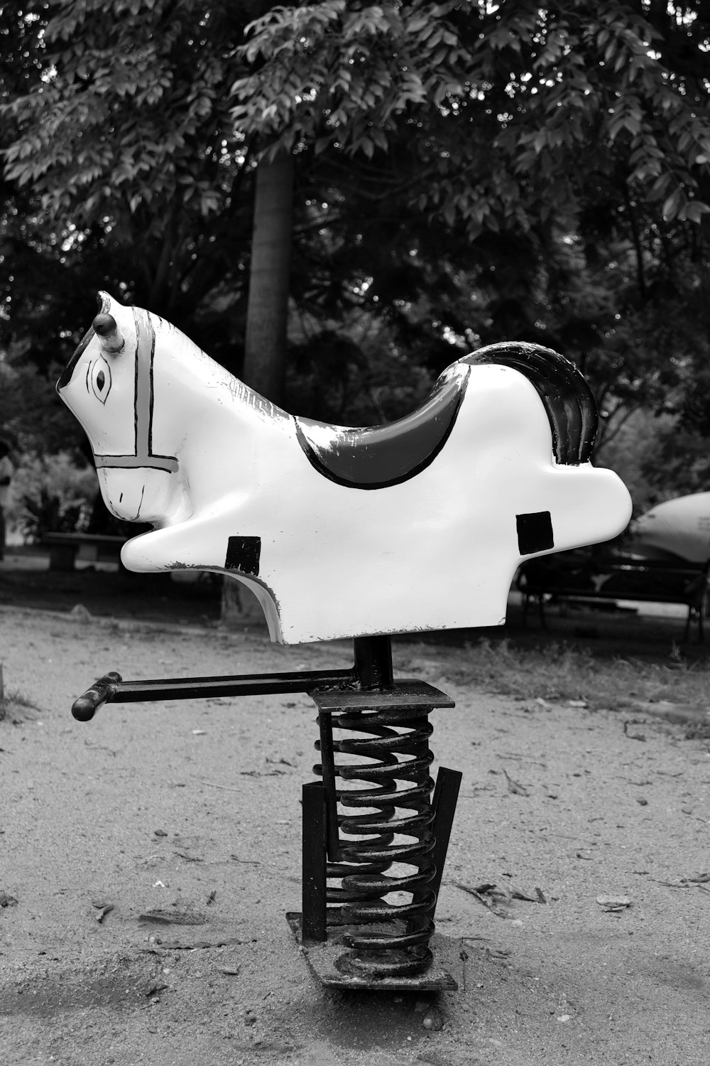 a black and white photo of a toy horse